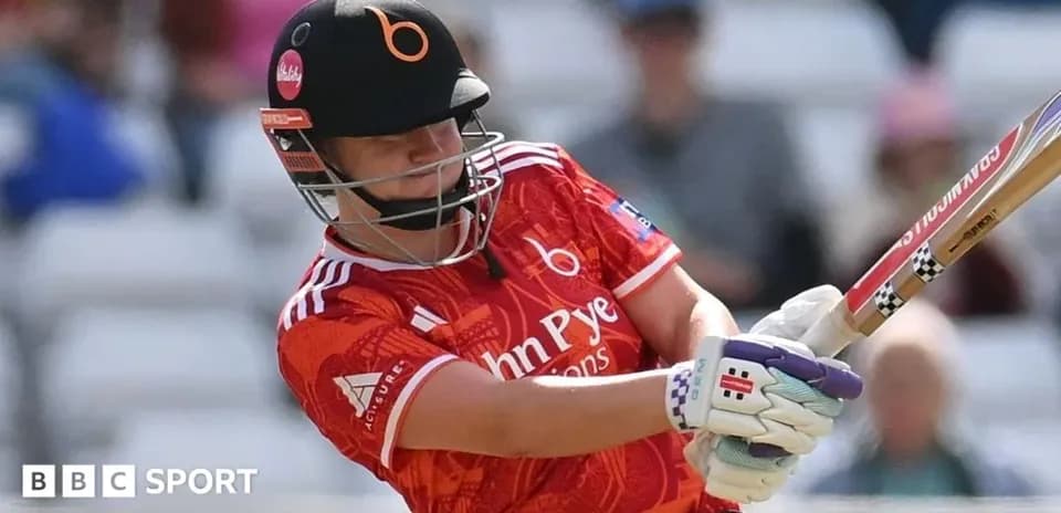 Batsman striking the ball in a cricket match