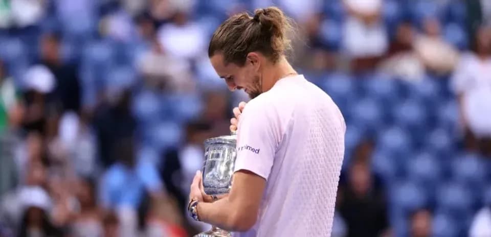 Player holding trophy after winning match