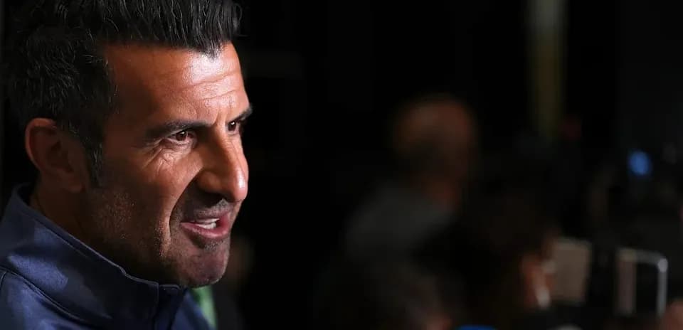 Man speaking during a press conference with microphones