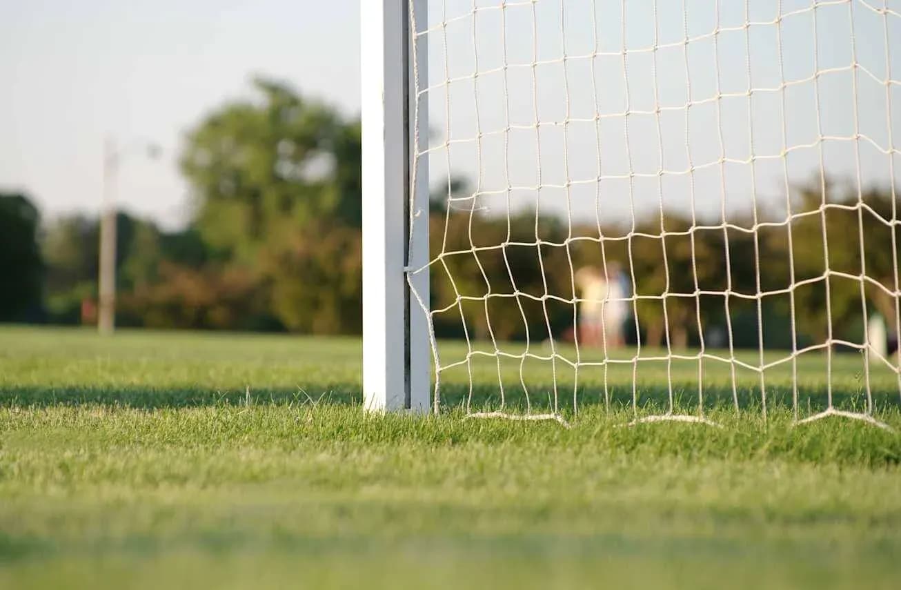 Close-up of soccer goal net on field