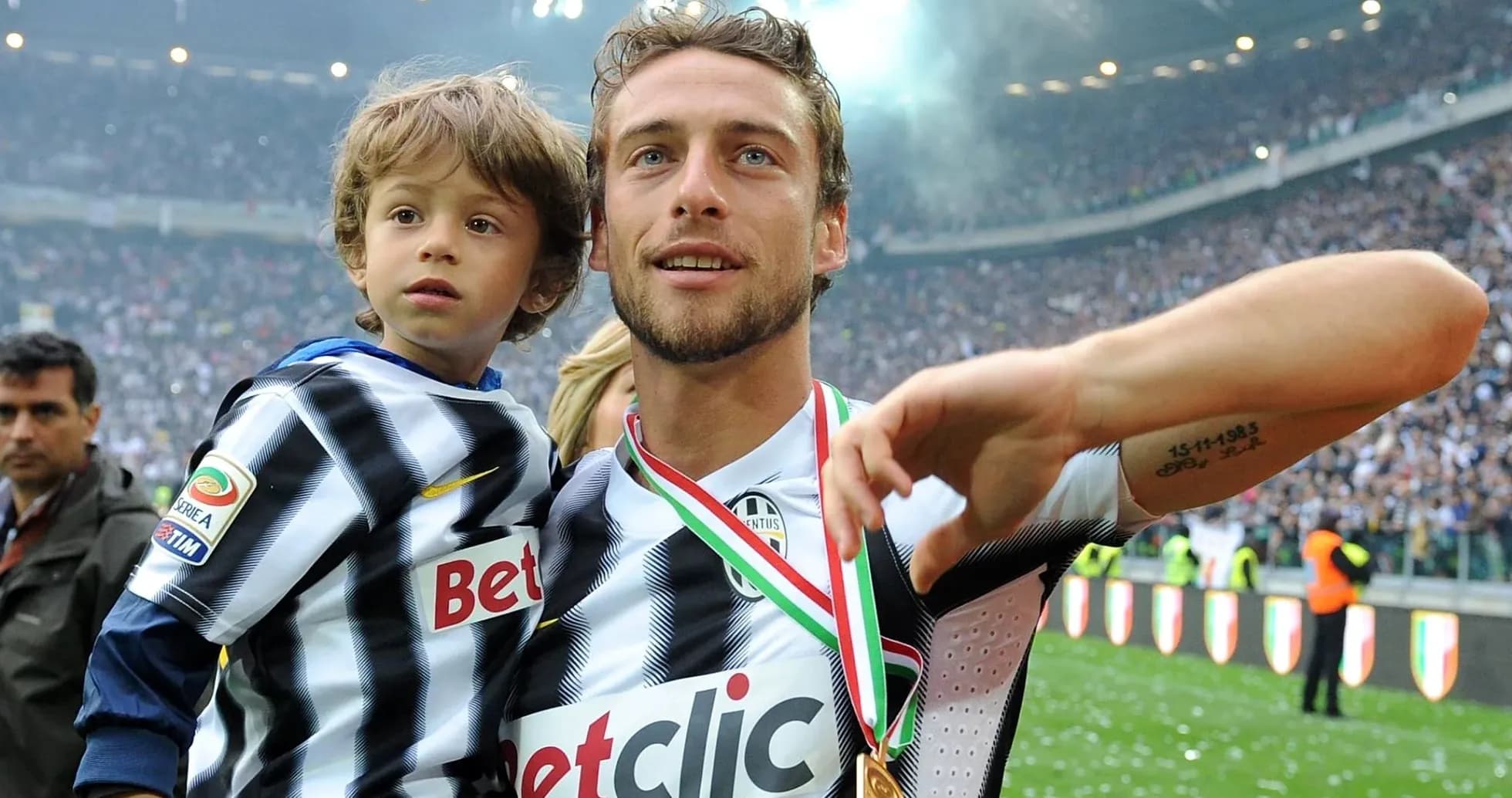 Player celebrating with child on the pitch