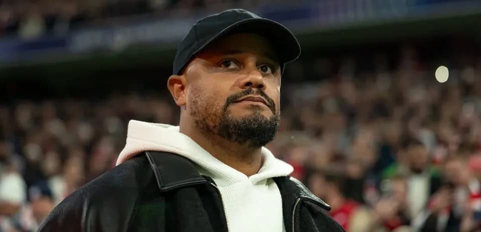 Man wearing a cap and jacket in stadium crowd