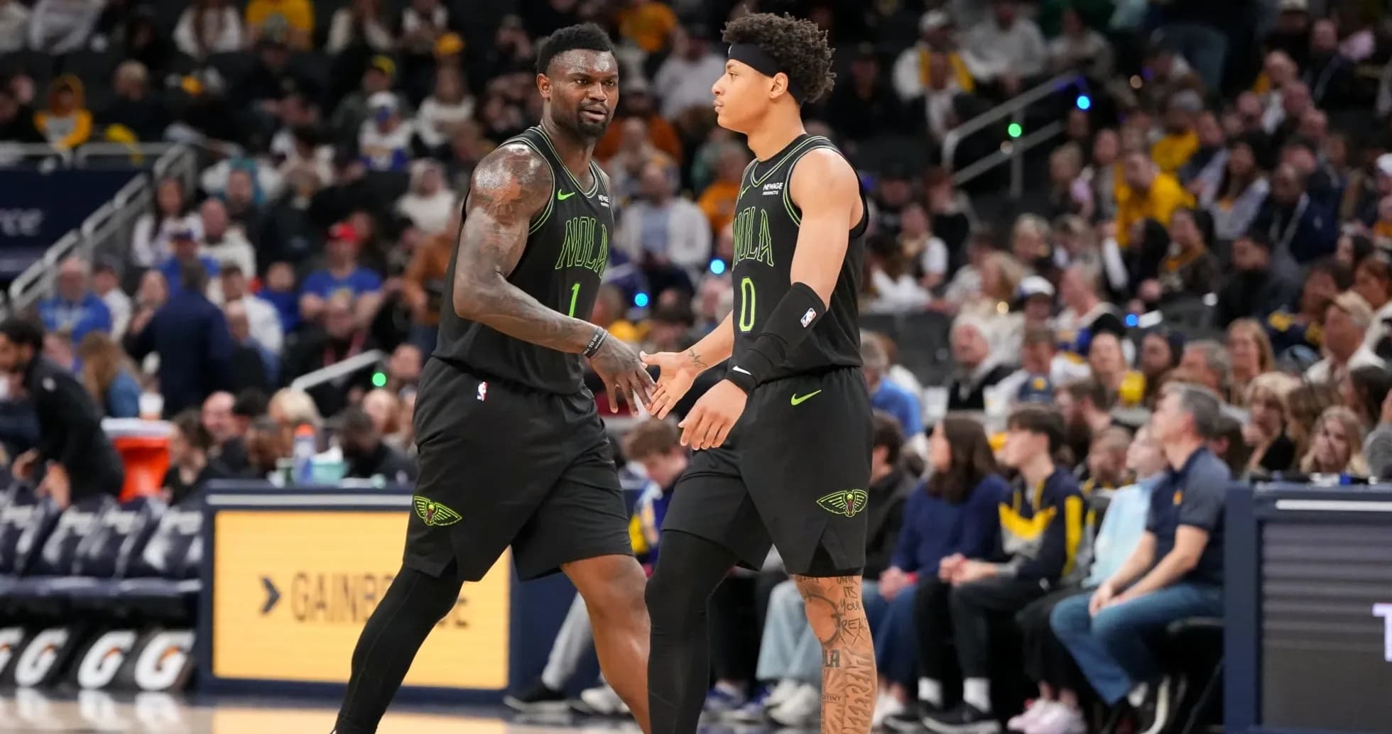 Two basketball players exchanging a handshake on court