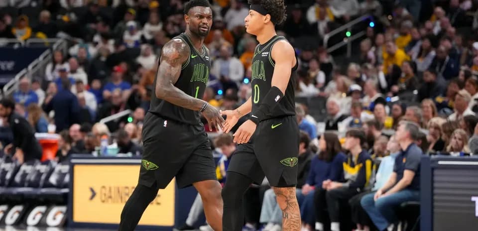 Two basketball players exchanging a handshake on court