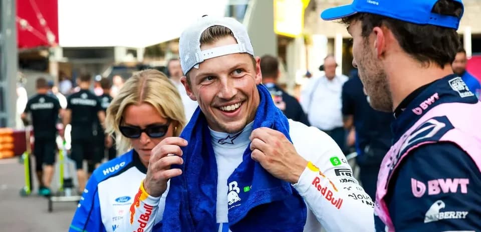 Two drivers chatting in paddock after race