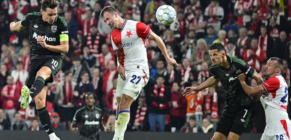 Players contesting for the ball during football match