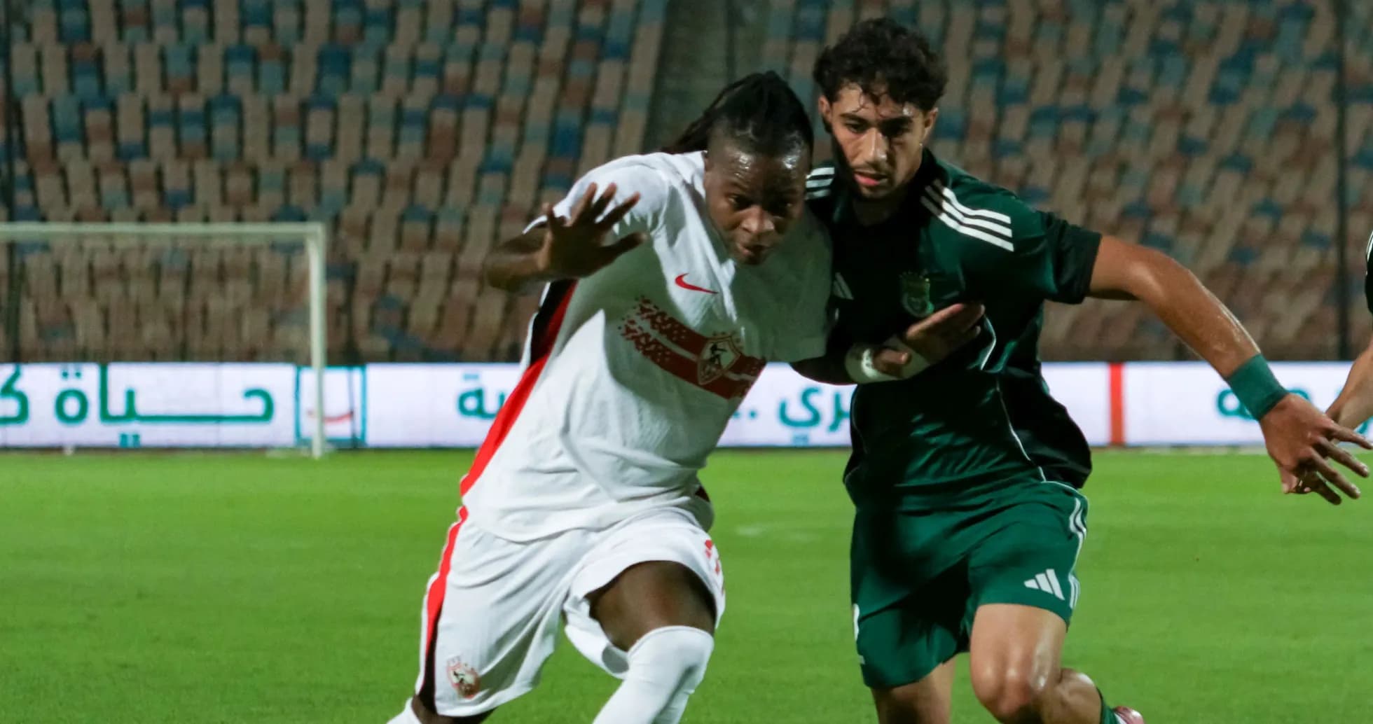 Two players battling for the ball during match