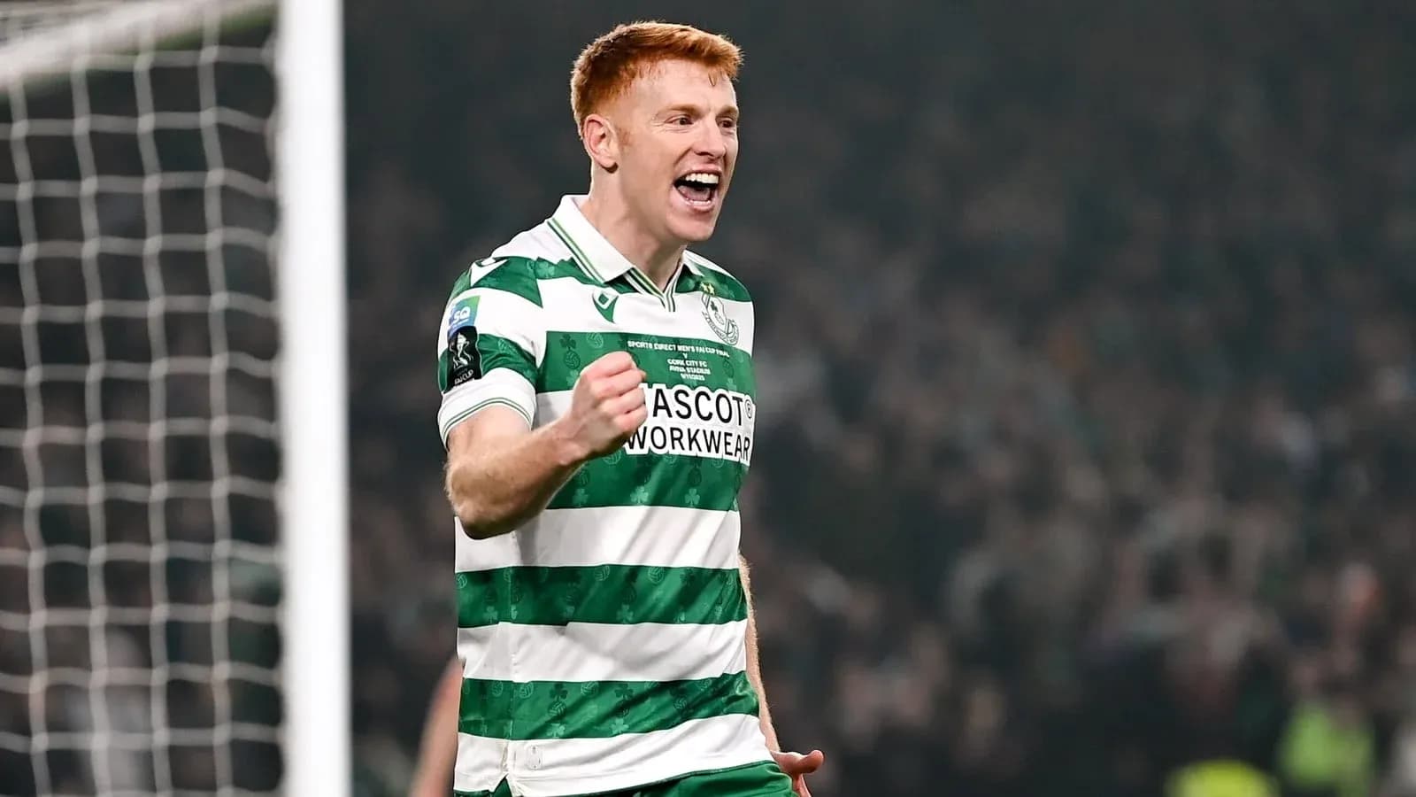 Player celebrating a goal in green and white jersey