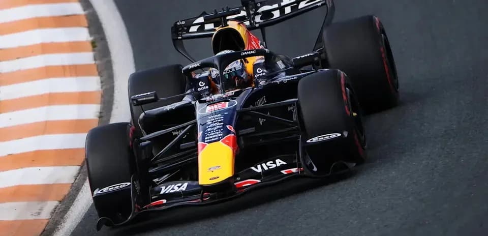 Formula 1 car navigating a sharp turn on track