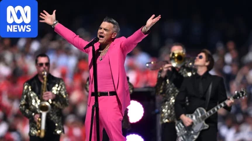 Performer in pink outfit singing with band