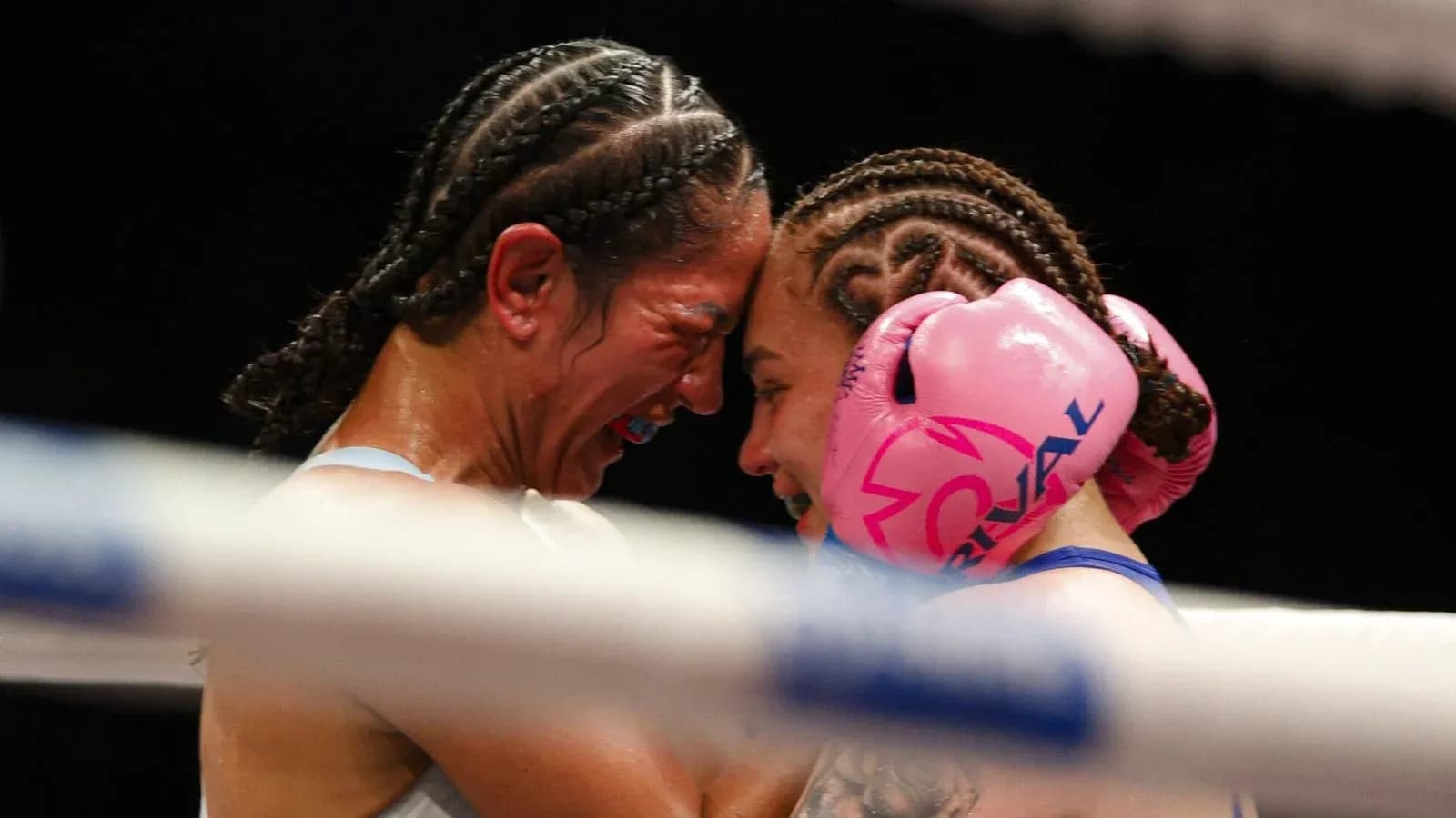 Two female boxers embracing in the ring