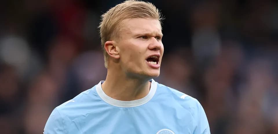 Player in Manchester City kit shouting on field