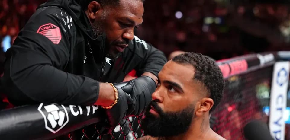 Coach advising fighter in MMA octagon corner