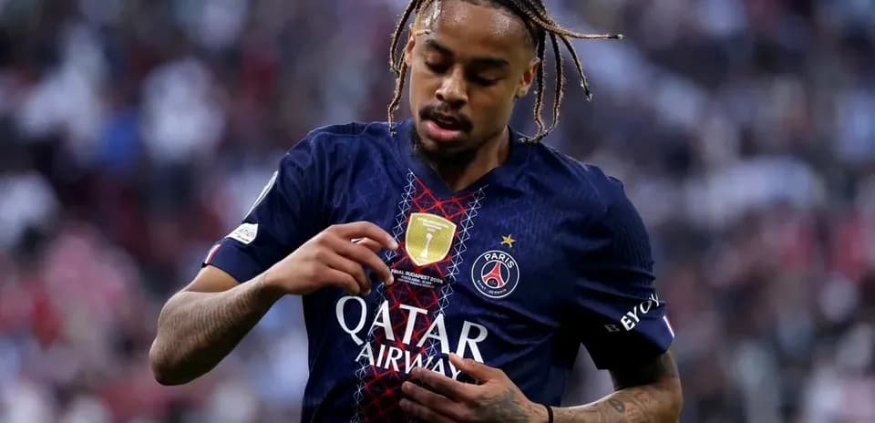 Player adjusting jersey with PSG logo during match