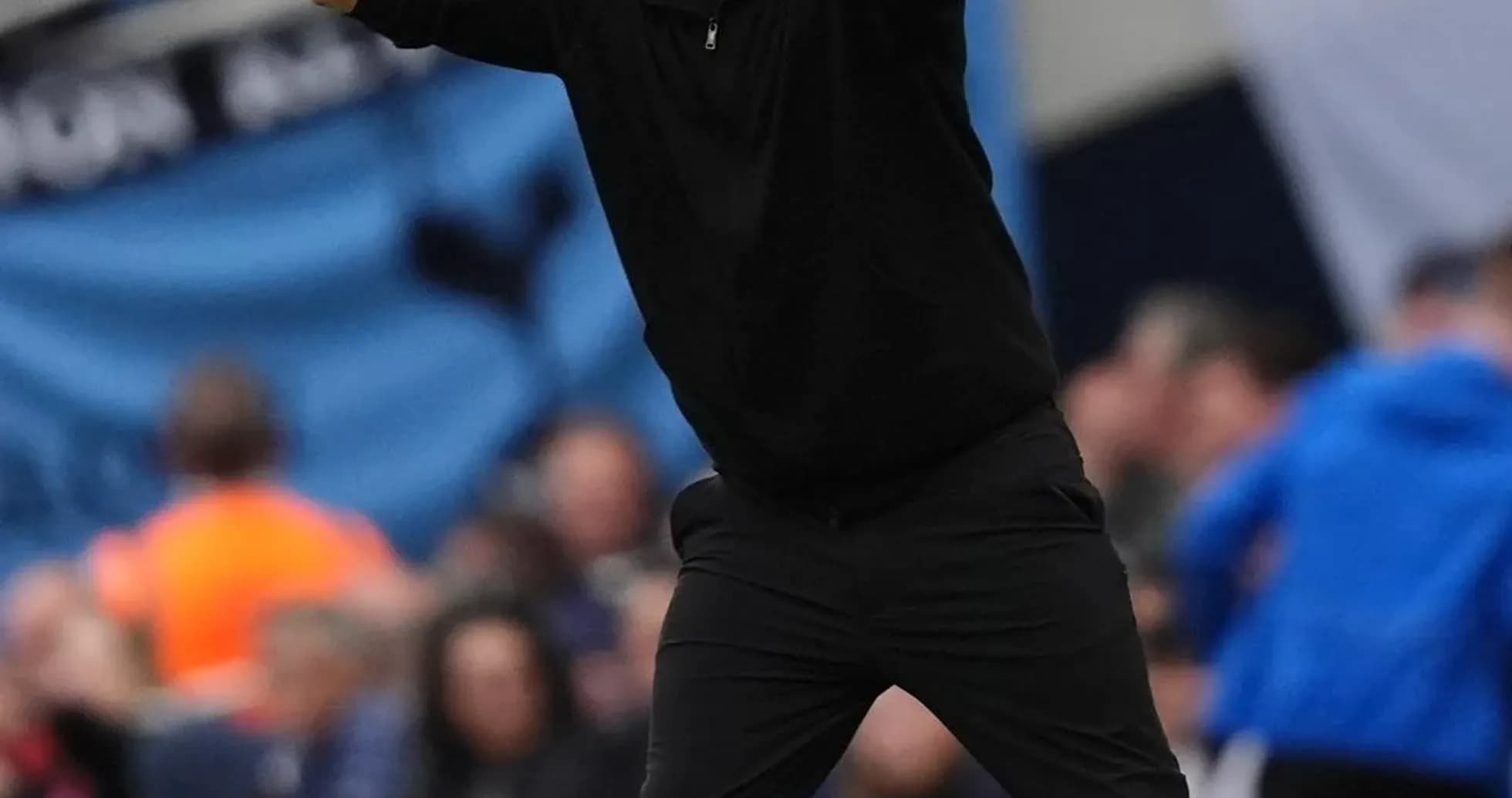 Coach gesturing during a football match on sideline