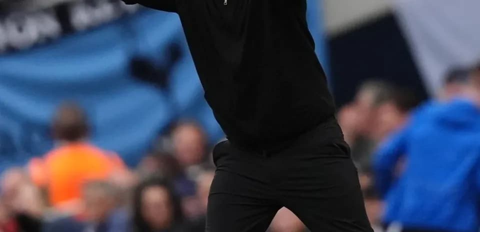 Coach gesturing during a football match on sideline