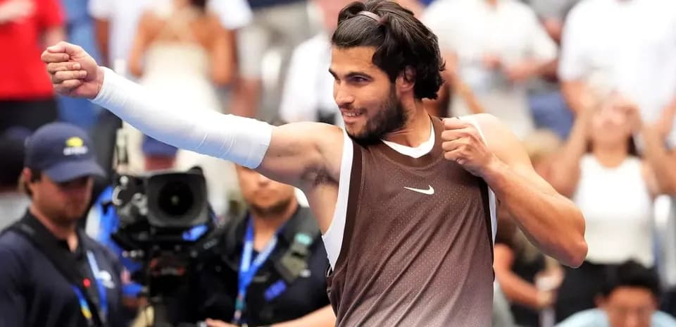 Tennis player celebrating with raised fist after match