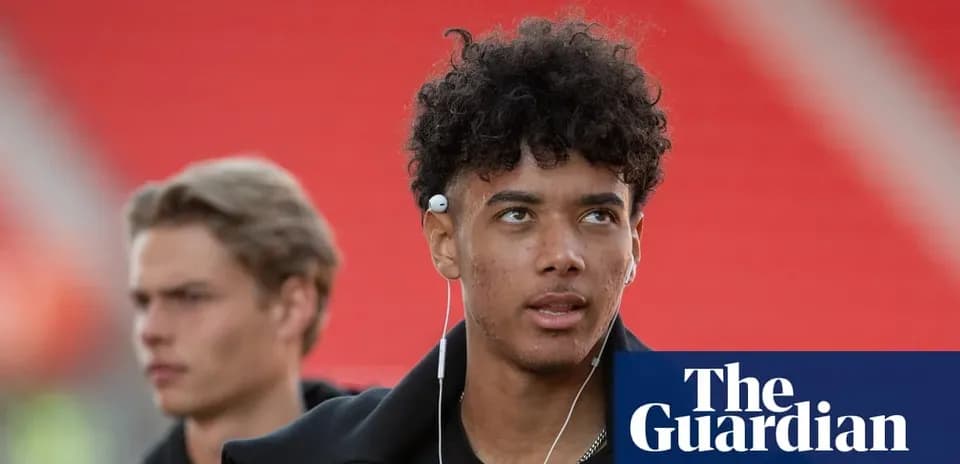 Player walking towards the stadium with headphones