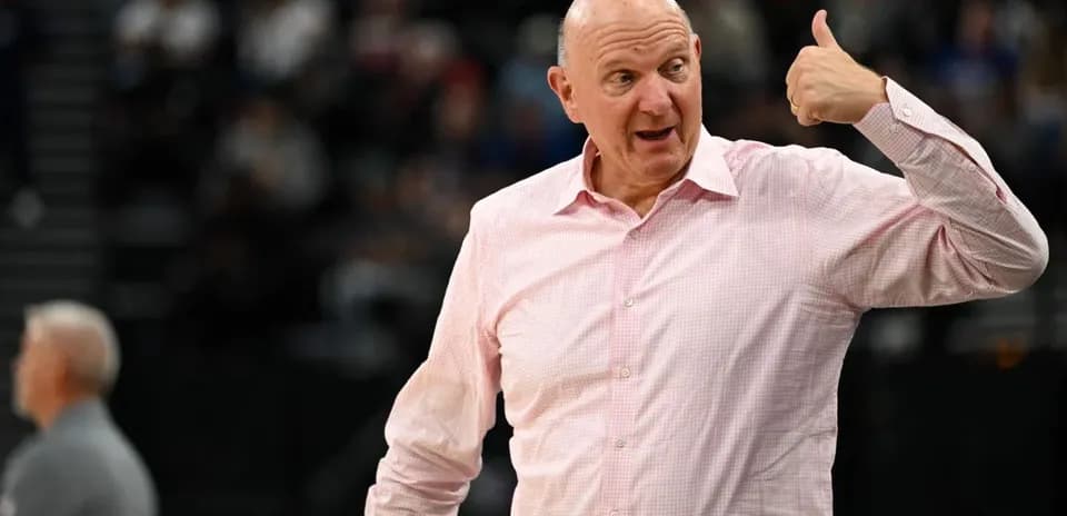 Man gesturing during basketball game at arena