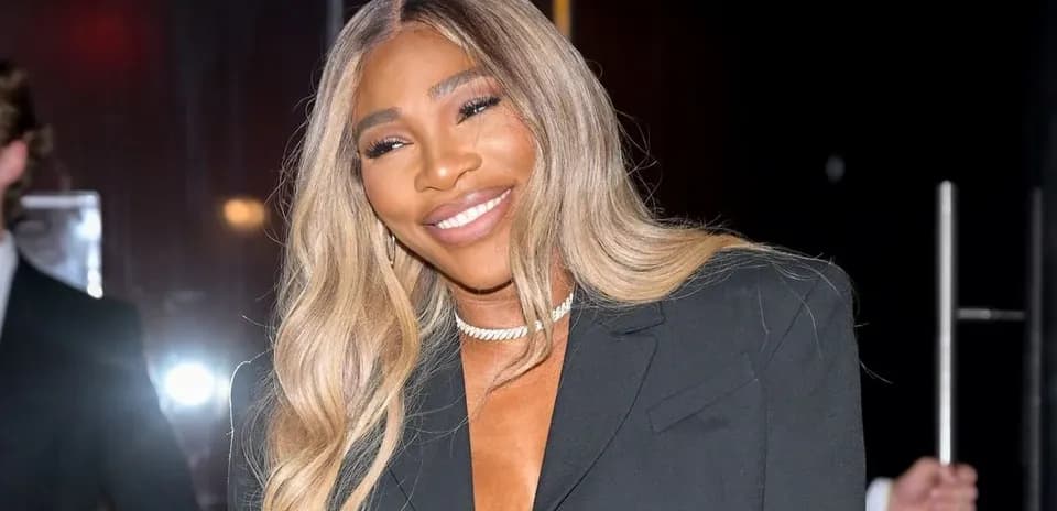 Person smiling in a stylish black outfit