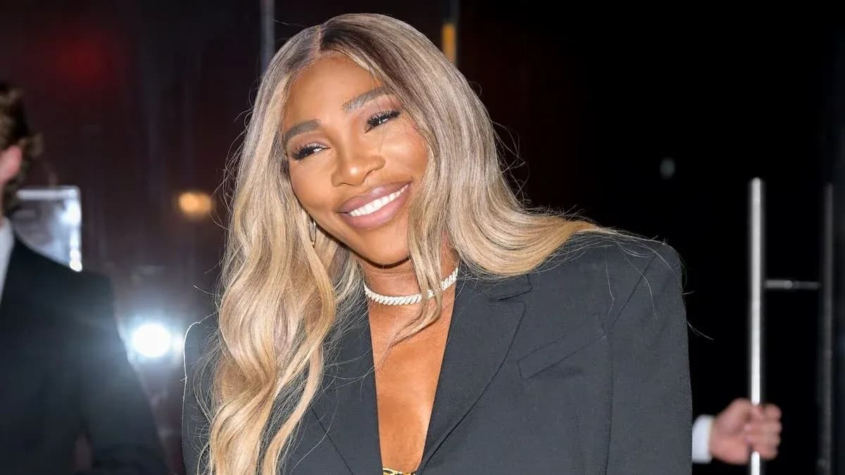 Person smiling in a stylish black outfit