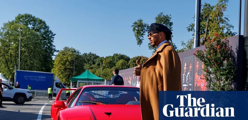 Person standing next to a red sports car