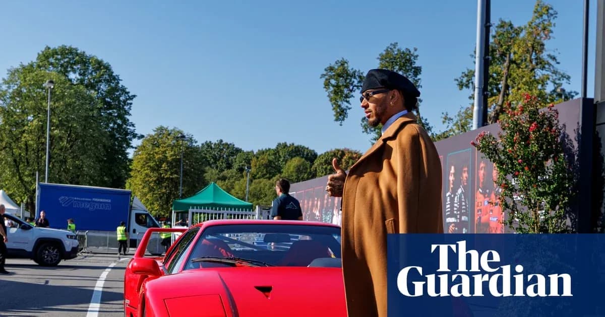 Person standing next to a red sports car