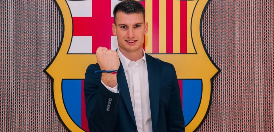 New player posing with FC Barcelona logo backdrop