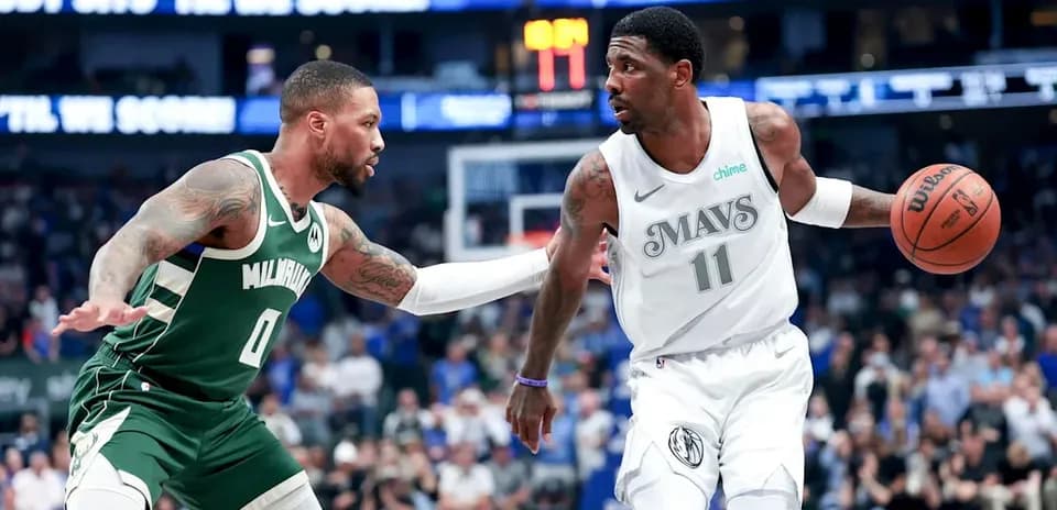 Two basketball players competing for possession on court