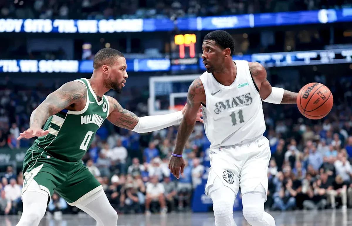 Two basketball players competing for possession on court