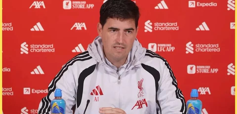 Manager speaking at Liverpool press conference table
