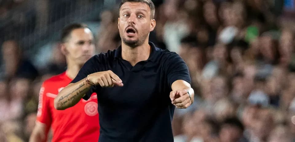 Coach directing players during a match on the sideline
