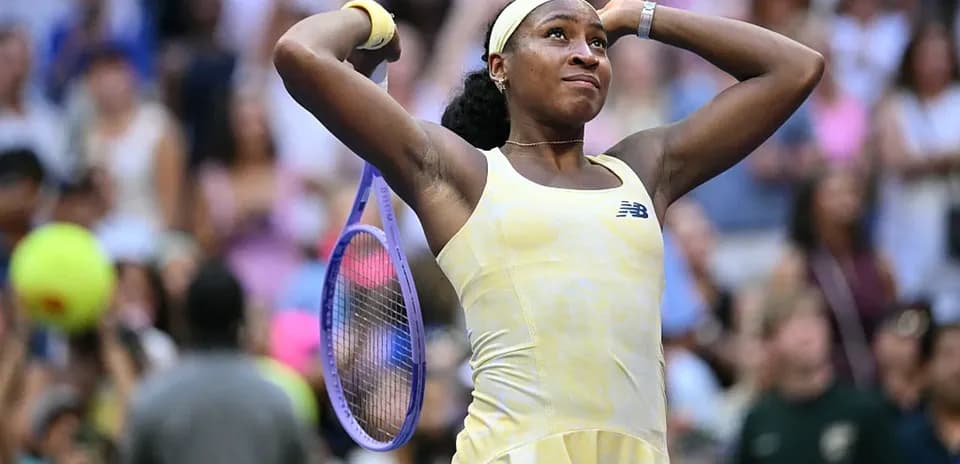 Coco Gauff celebrating with her racket at match