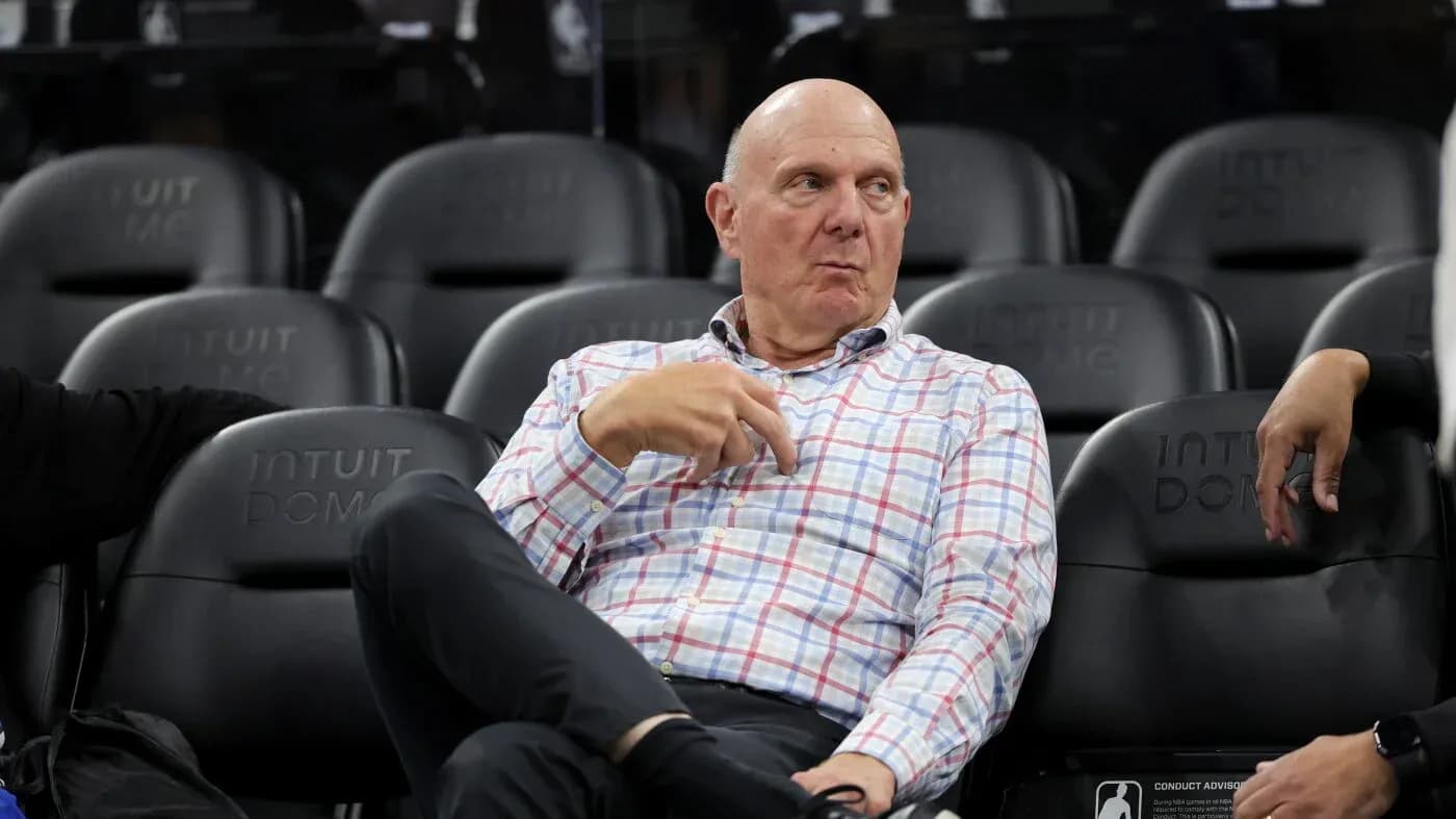Man sitting on bench at basketball arena