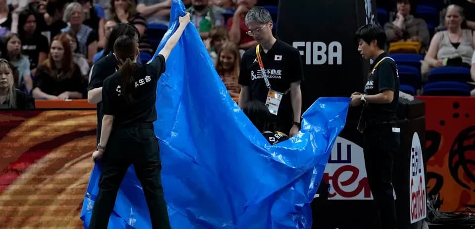 Staff preparing to cover the court with tarp