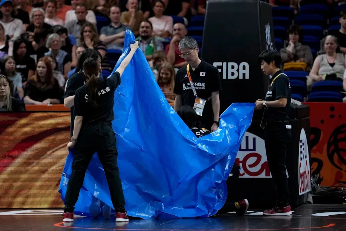 Staff preparing to cover the court with tarp