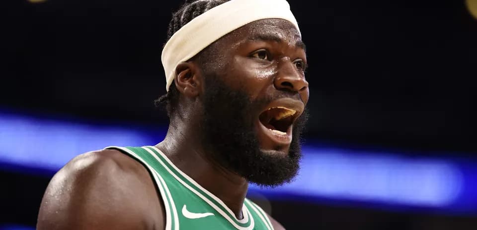 Player shouting on court wearing green jersey