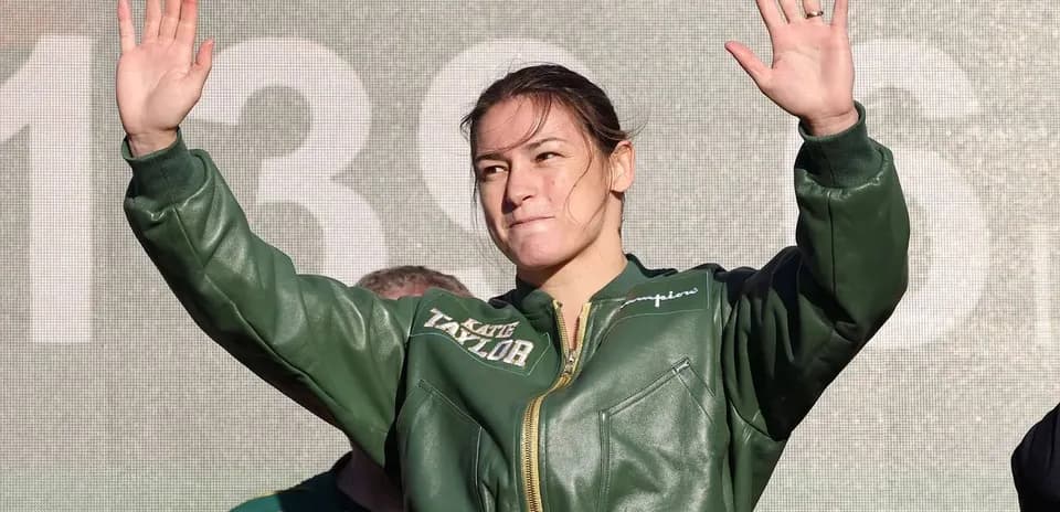 Boxer waving during pre-fight event on stage