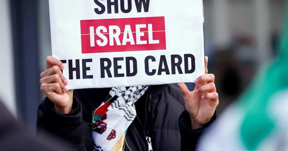 Protester holding sign reading 'Show Israel the red card'