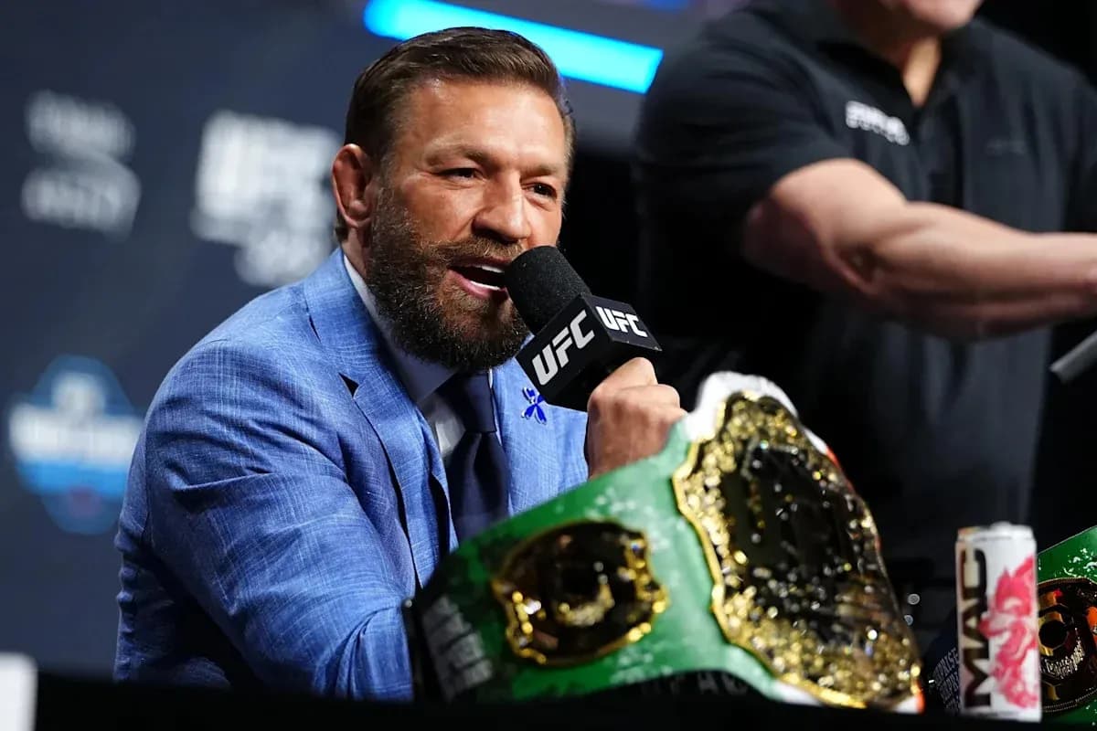 Fighter speaking at press conference with championship belt