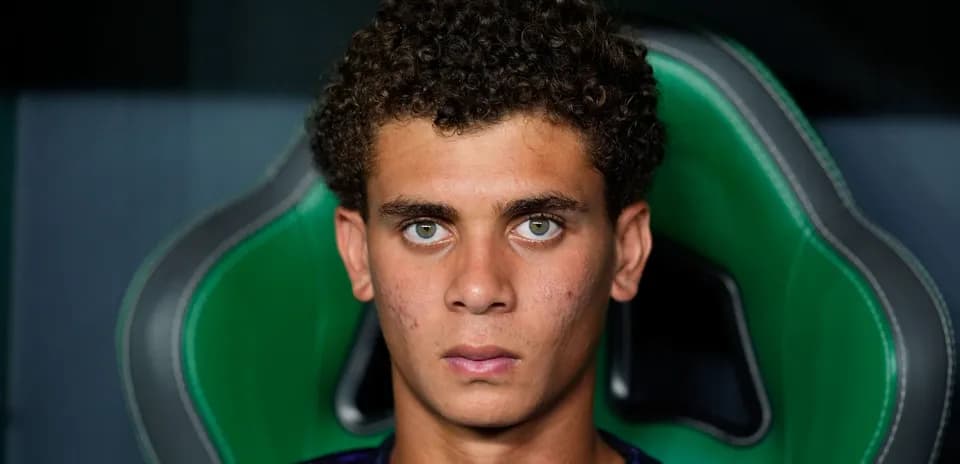 Young player seated in sports chair, focused expression