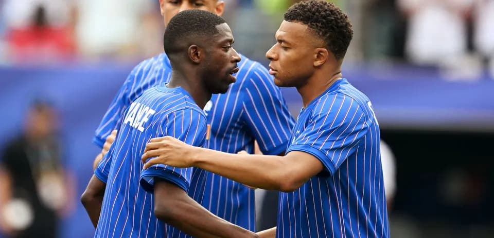 Two players in blue jerseys greeting each other