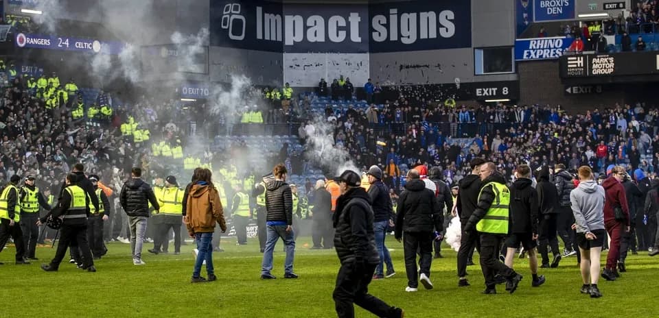 Fans on the pitch during a heated match incident