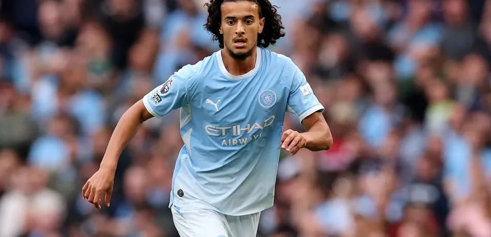 Player in light blue kit running on the pitch