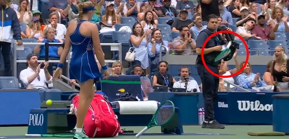 Tennis player preparing to serve with audience applauding