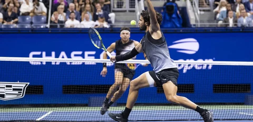 Player reaching for a tennis ball during match
