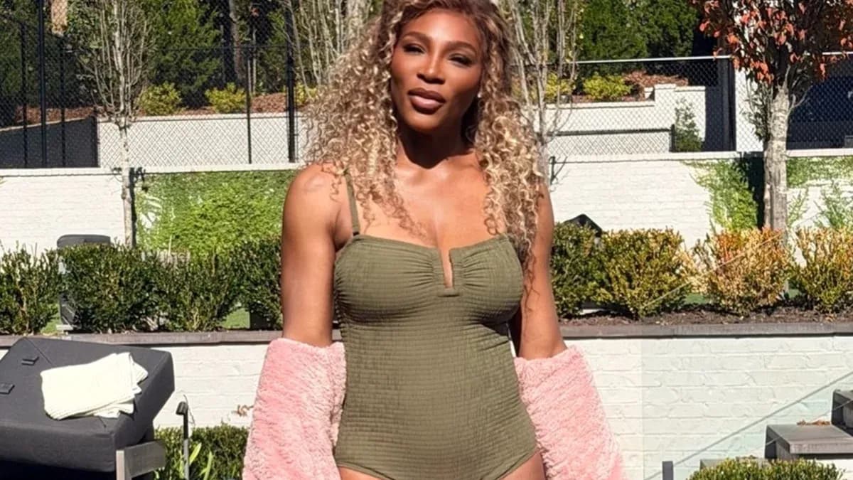 Person in swimsuit posing outdoors with greenery