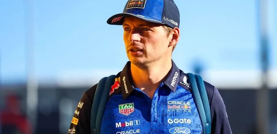 Driver wearing team gear walking in paddock