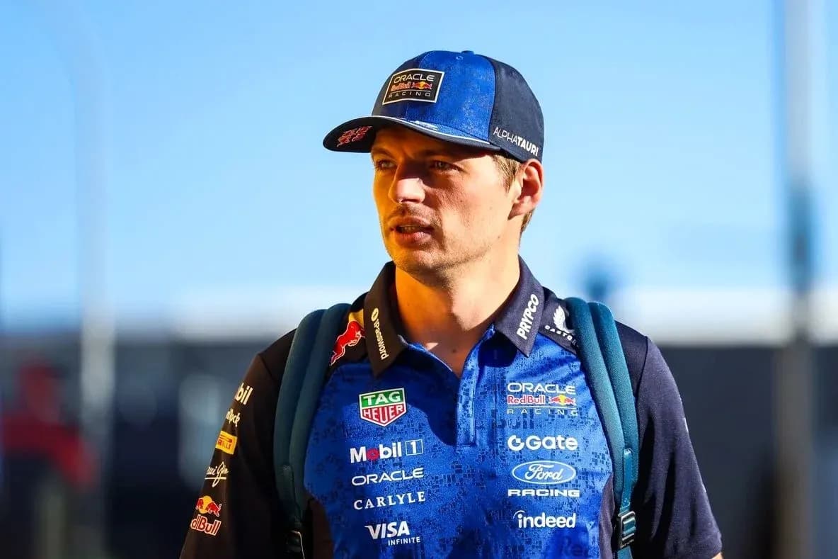 Driver wearing team gear walking in paddock