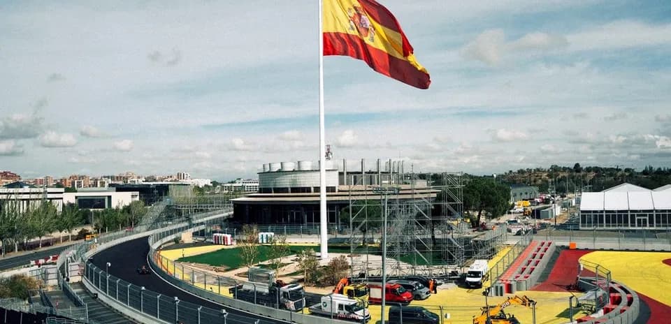 Spanish flag flying above a racetrack under construction
